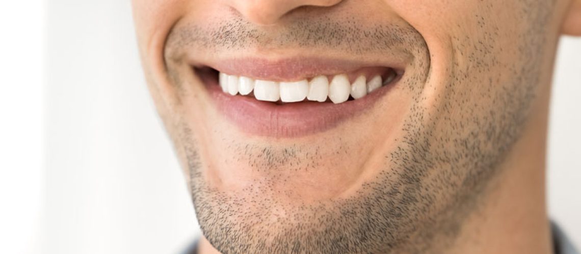 a man smiling with a perfect smile